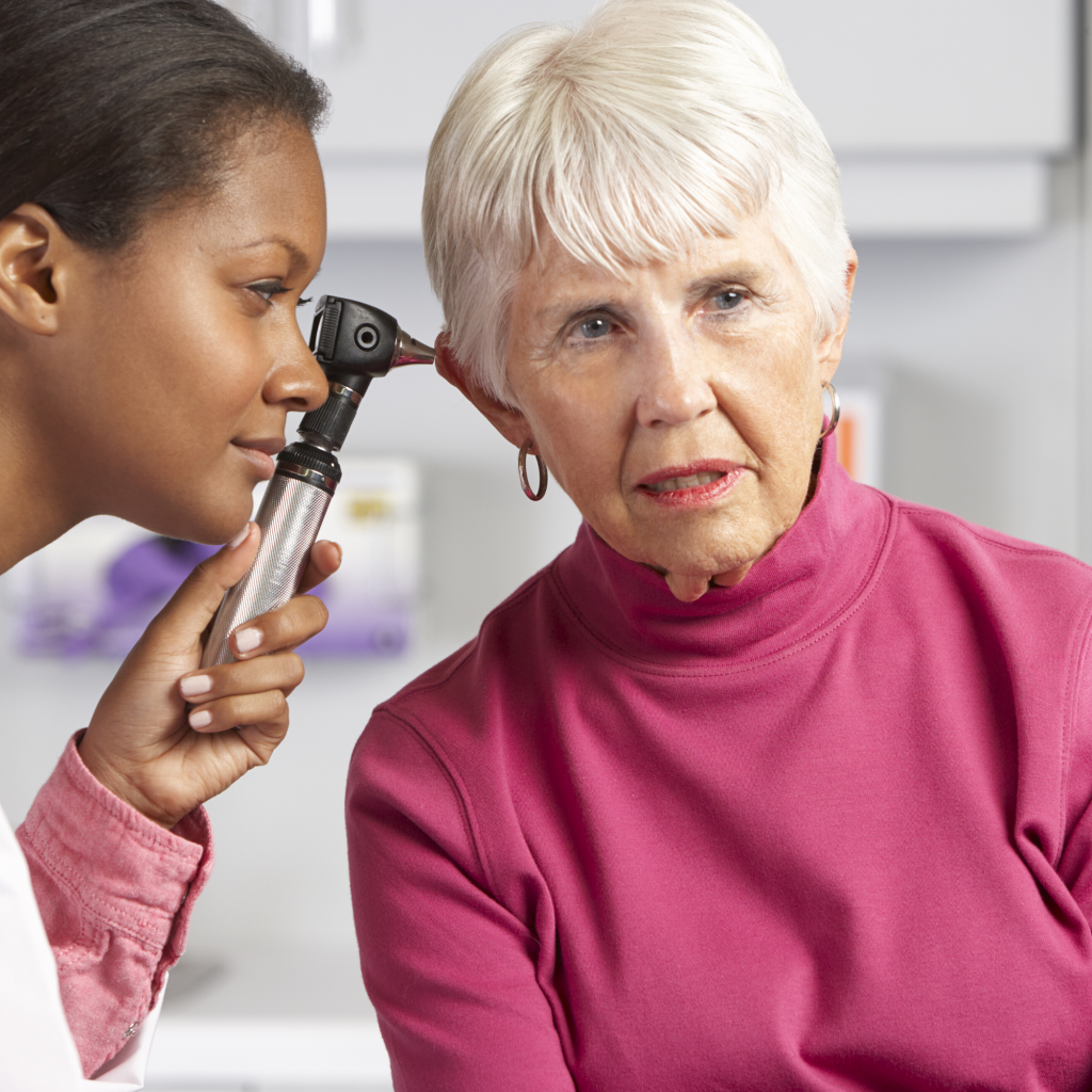 Examining elderly woman ear