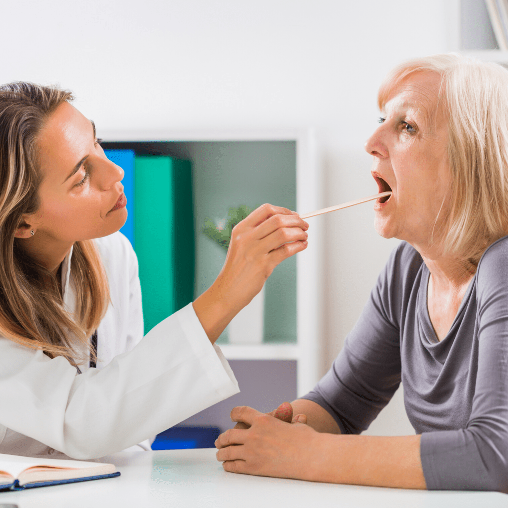 Doctor checking woman's throat