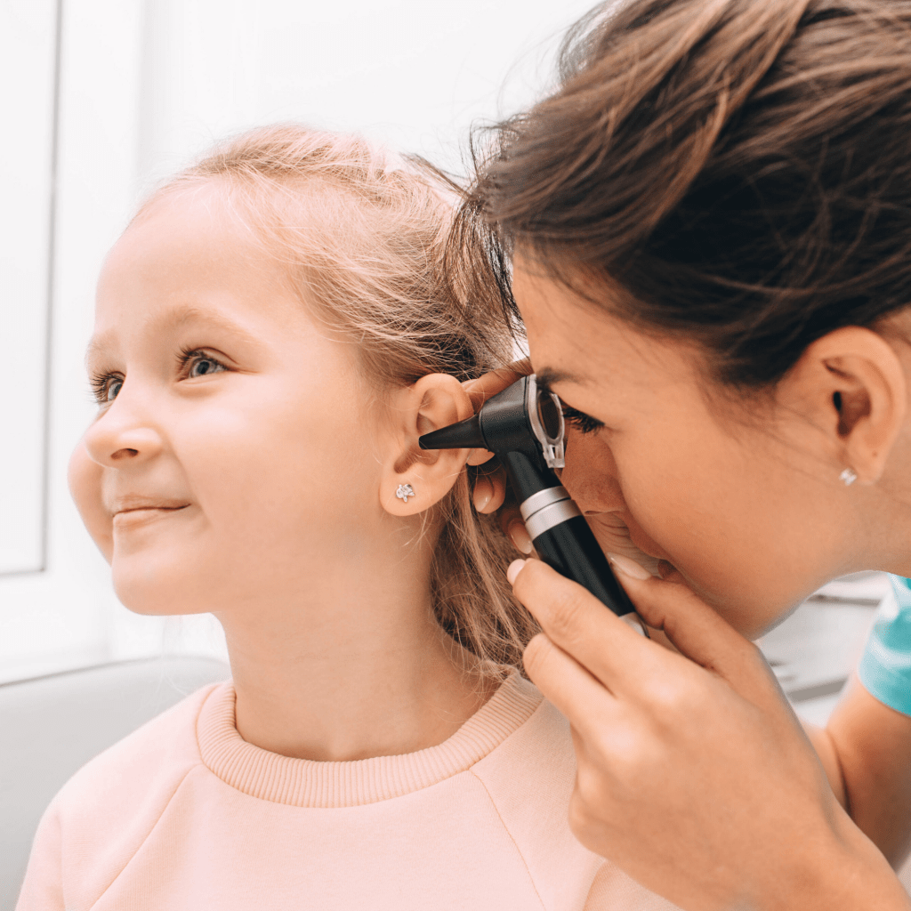 ENT doctor examining child's ear