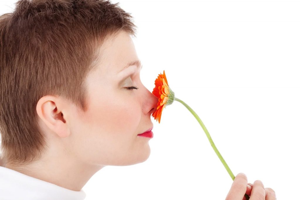 woman smelling flower